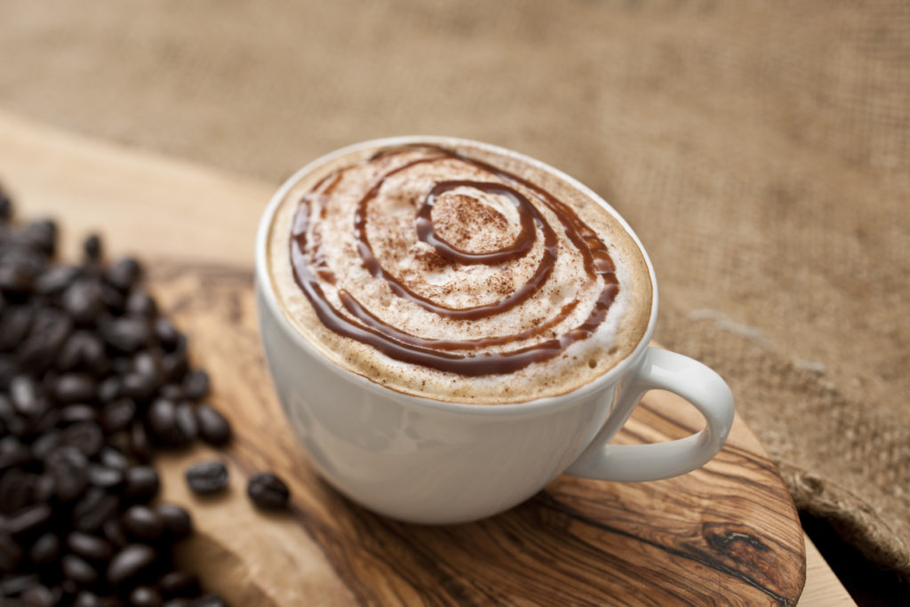 mocha coffee topped with swirls of chocolate and cream.